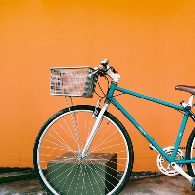 Blue bike against orange background