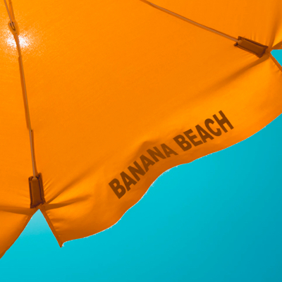 Orange umbrella against blue sky